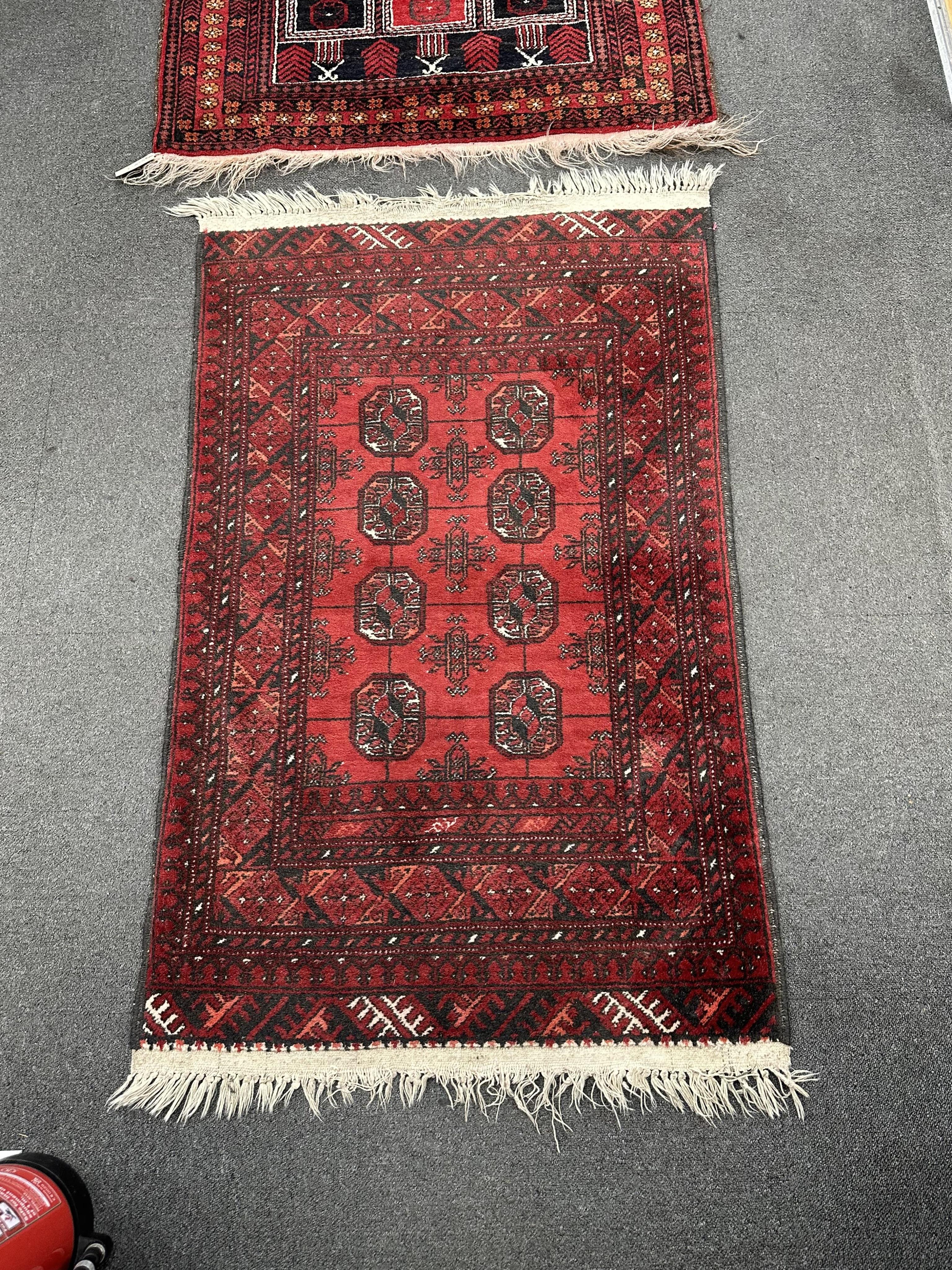 A Belouch prayer rug and Bokhara rug, larger 140cm x 95cm. Condition - fair.